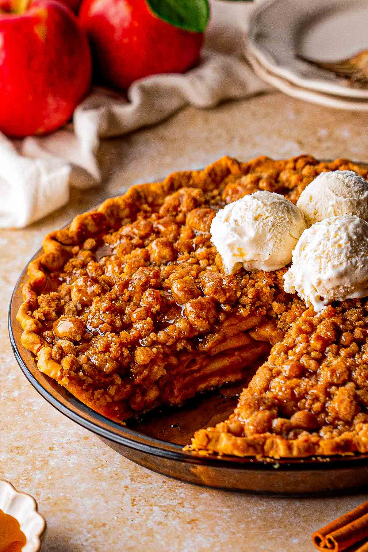 Close-up of sliced apples beneath the crumble topping in a Dutch caramel apple pie.