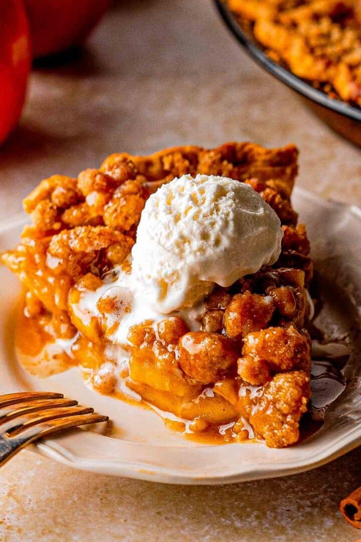 Dutch caramel apple pie with golden brown crumble topping and caramel drizzle