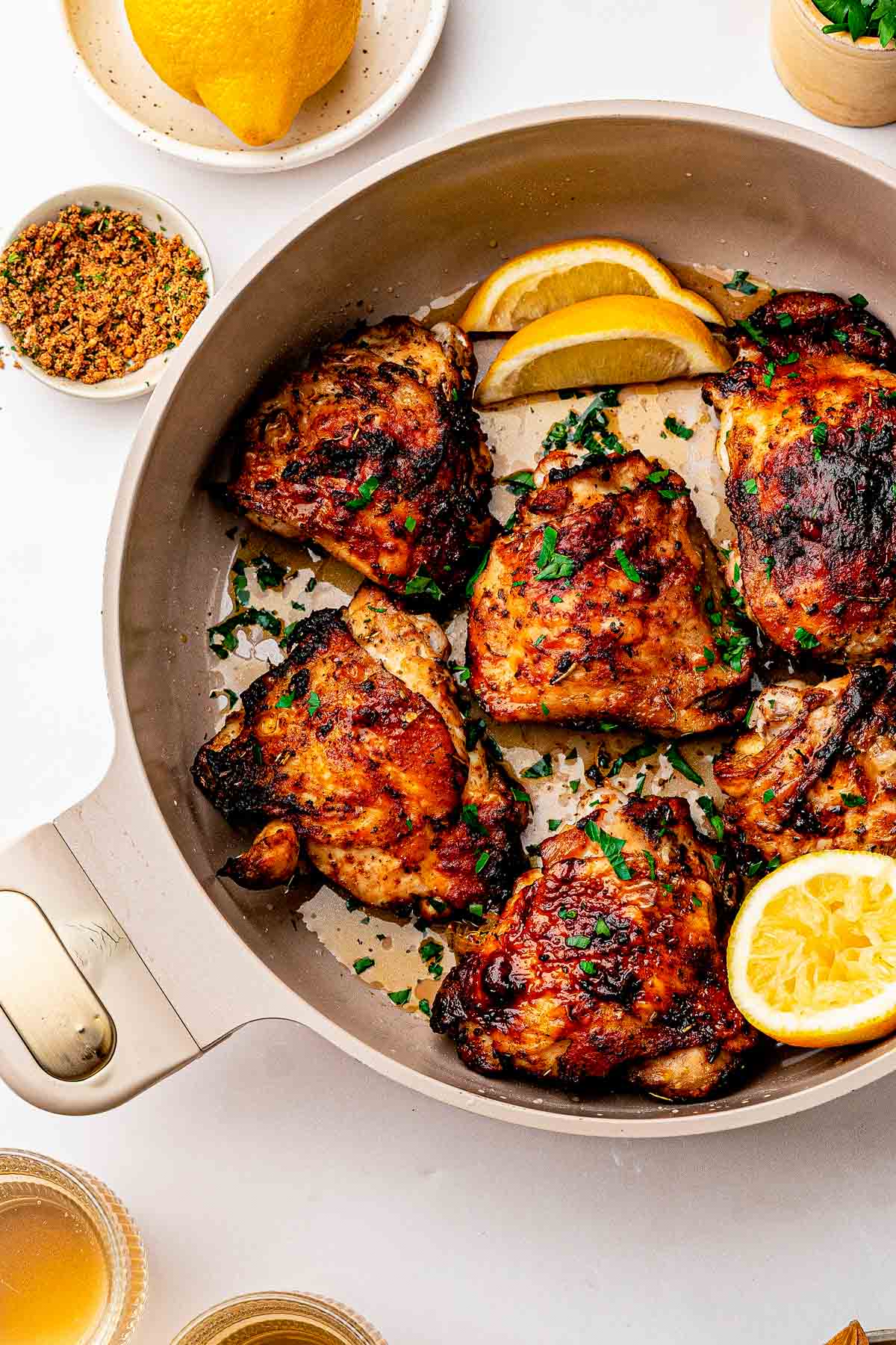 Close-up of golden crispy skin on dry rub chicken thighs coated in homemade lemon pepper rub