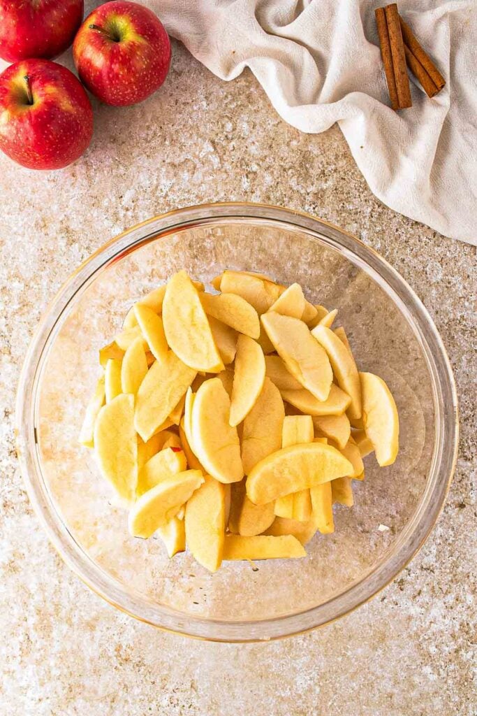 Sliced apples in a mixing bowl