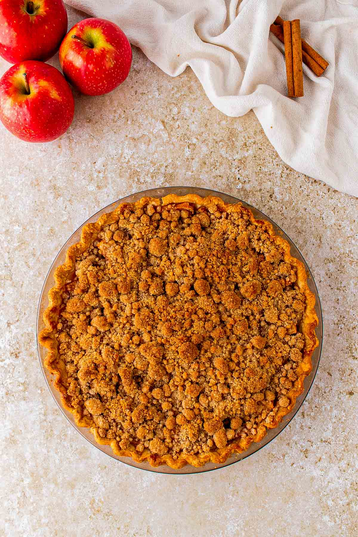 Baked Dutch apple pie with golden crumble and filling bubbling around the edges.