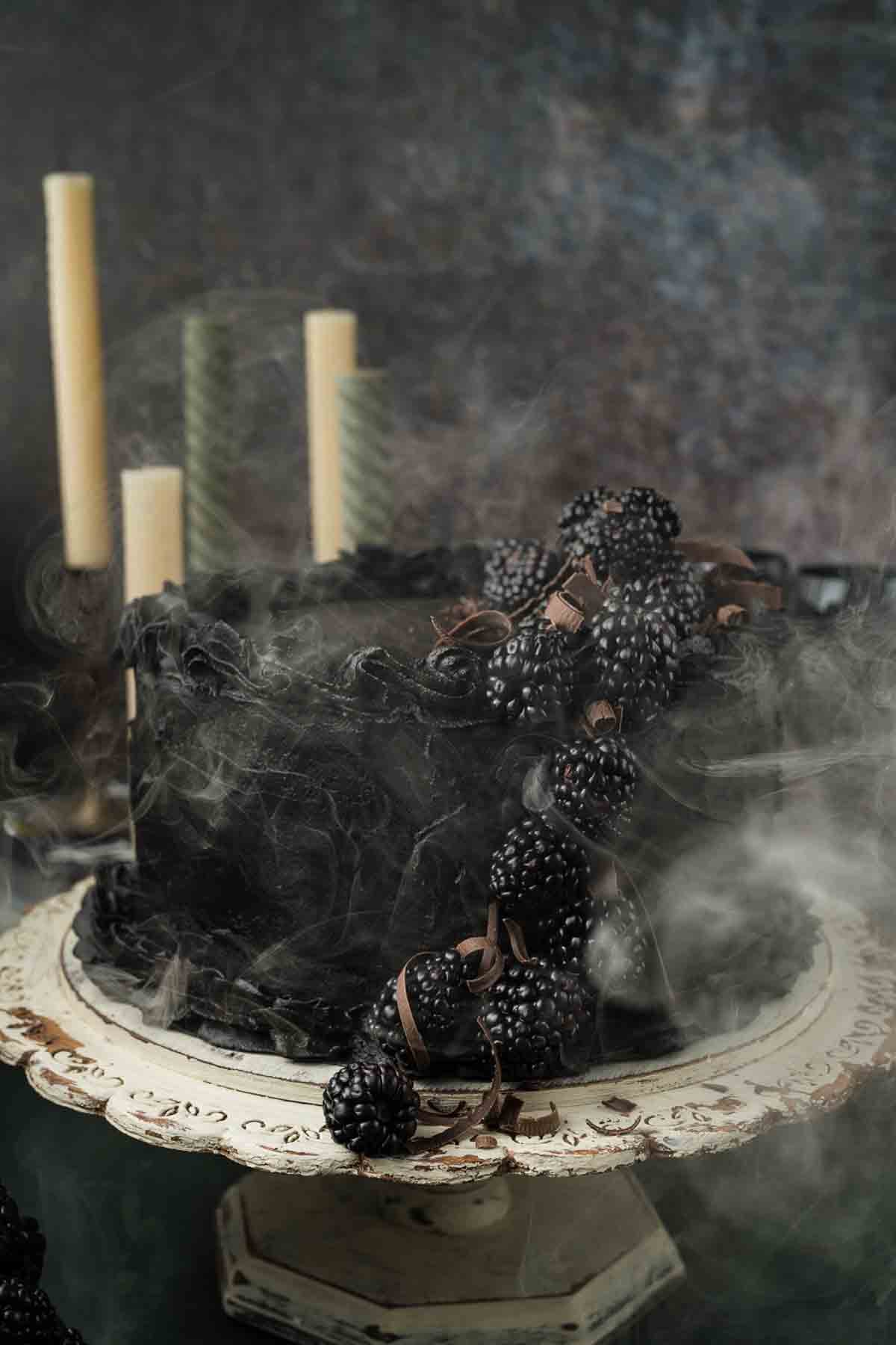 Spooky and smokey Halloween style velvety crumb of a black cocoa cake with buttercream filling