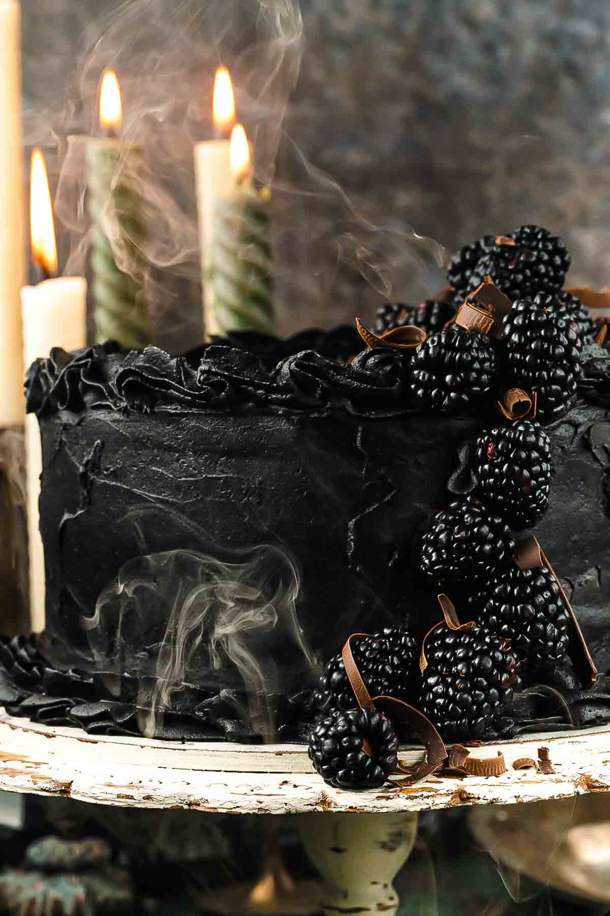 black velvet cake with blackberries wit smoke on Halloween